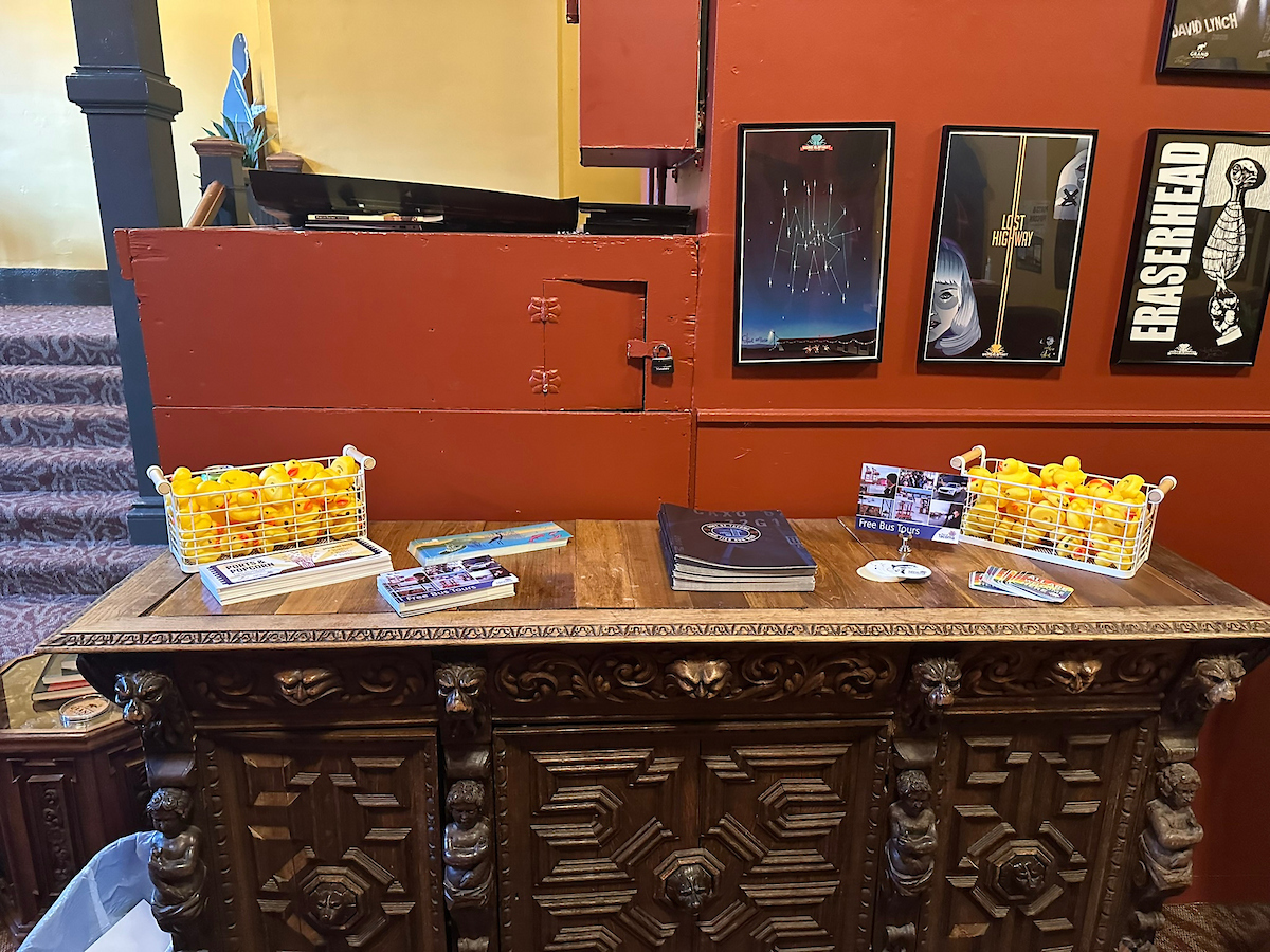 A vintage table with Port flyers and two baskets of small rubber ducks.