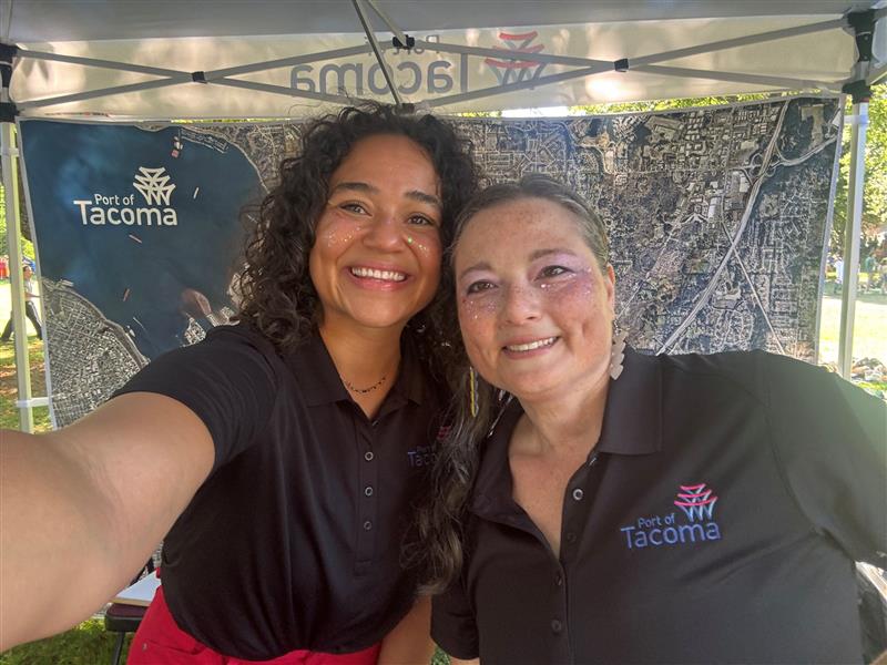 Two women in polos taking a selfie.