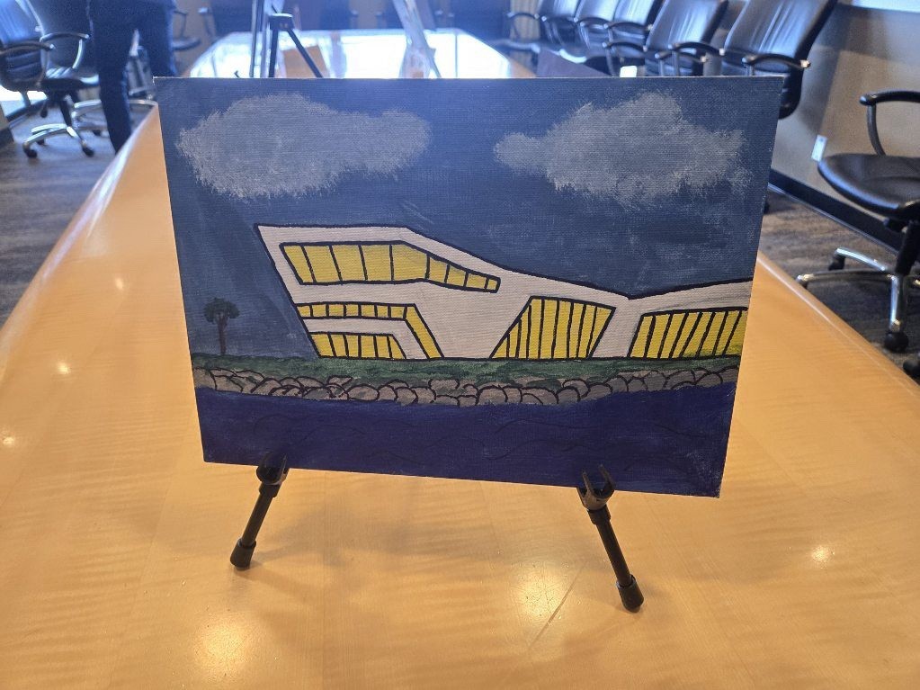 Student-created painting of a rendering of the Maritime Center building at sunset.